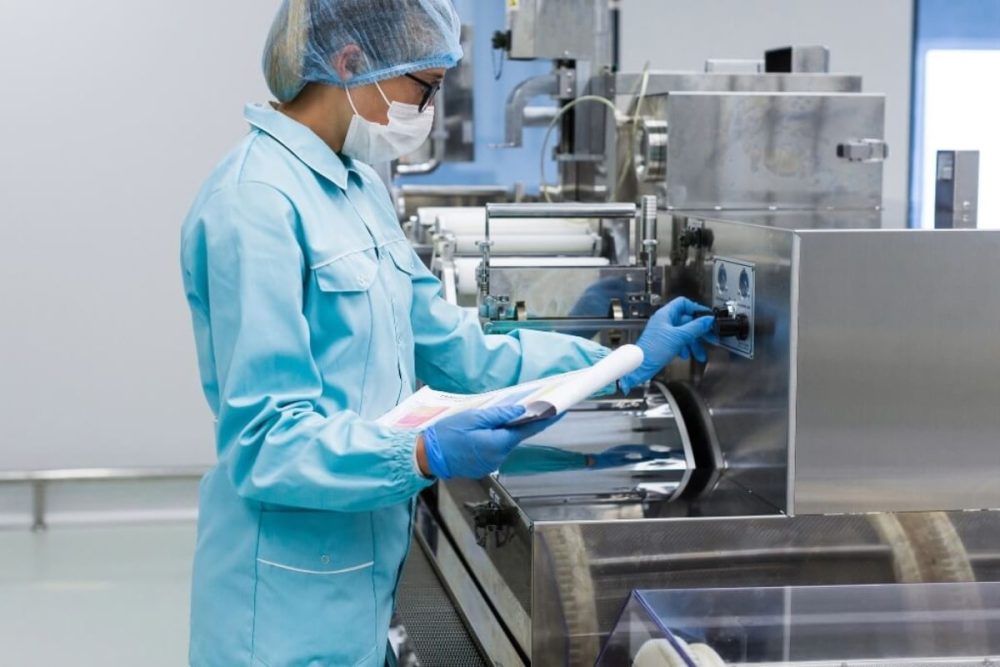 Food processing worker in hygienic, protective clothing.