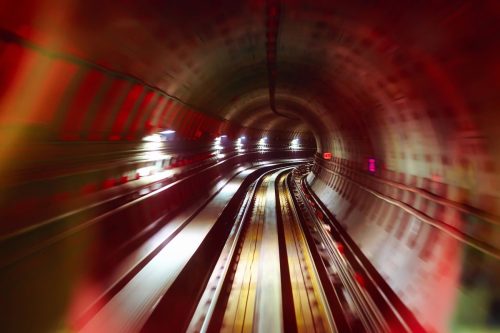 Underground rail tunnel, slightly blurred indicating motion.